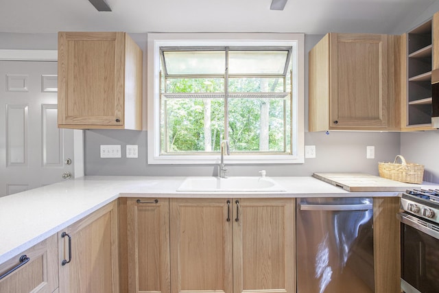 kitchen with light brown cabinetry, appliances with stainless steel finishes, light countertops, and a sink