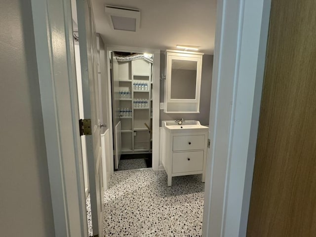 bathroom with vanity and speckled floor