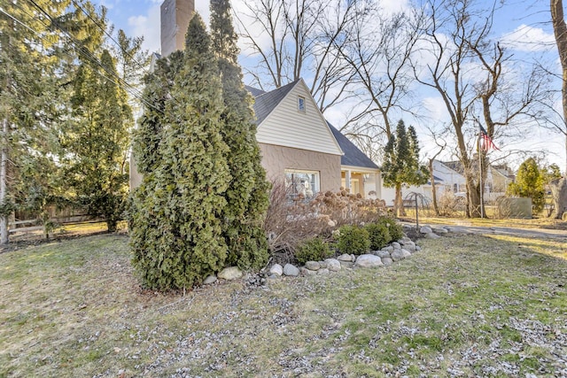 view of side of home with a lawn