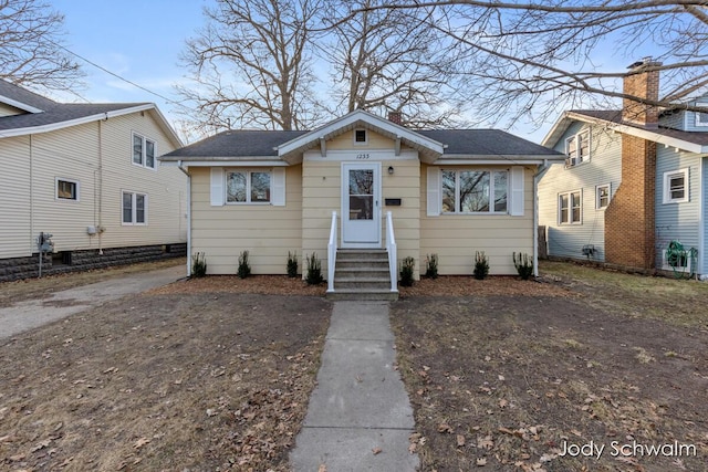 bungalow featuring a shingled roof and entry steps