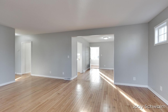 unfurnished room with visible vents, baseboards, and light wood finished floors