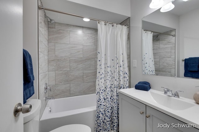 full bathroom with vanity, shower / bath combination with curtain, and toilet