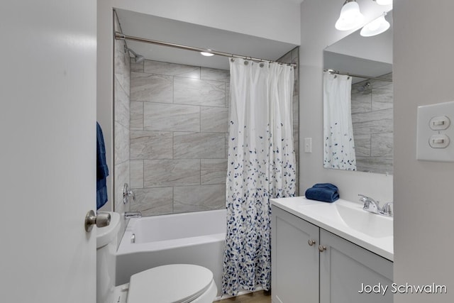 full bath featuring shower / bath combo with shower curtain, toilet, and vanity