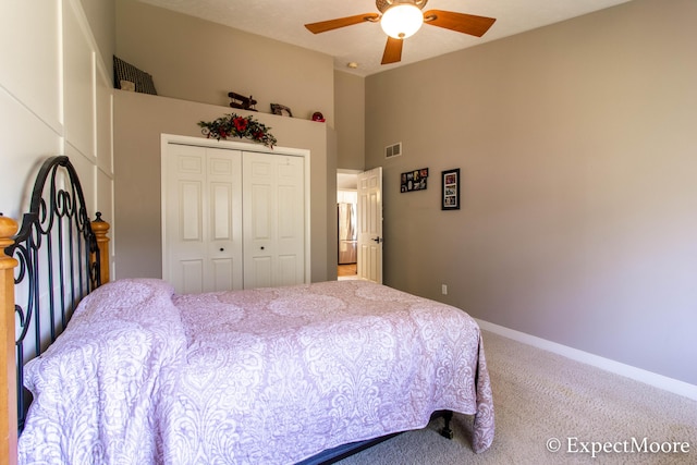 carpeted bedroom with visible vents, ceiling fan, baseboards, vaulted ceiling, and a closet