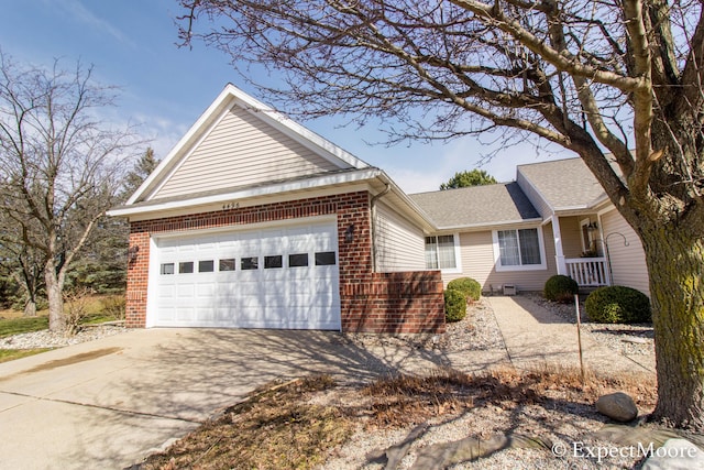 single story home featuring an attached garage, brick siding, driveway, and a shingled roof