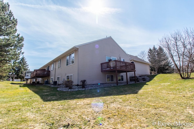 rear view of house with a lawn, central AC, and a deck