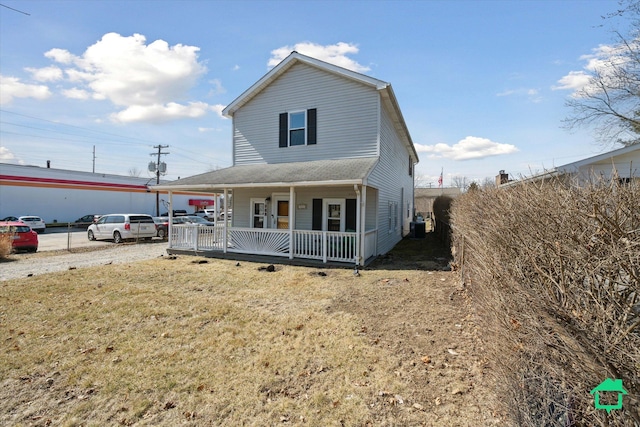 view of front of house with covered porch and a front yard