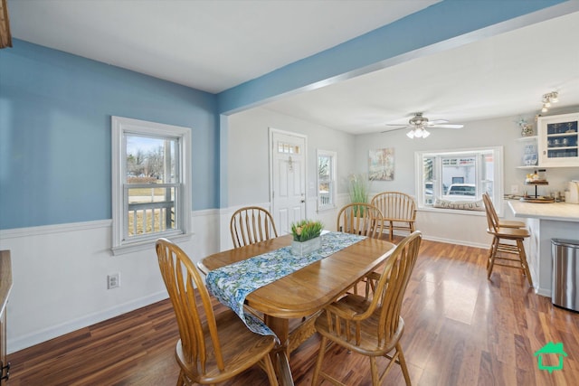 dining area featuring baseboards, a ceiling fan, and wood finished floors