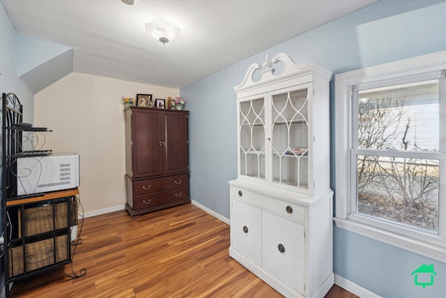 interior space featuring a wealth of natural light, light wood-type flooring, and baseboards