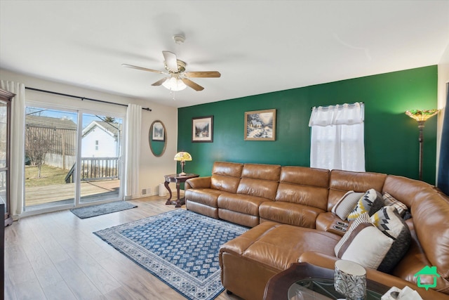 living room with ceiling fan and wood finished floors