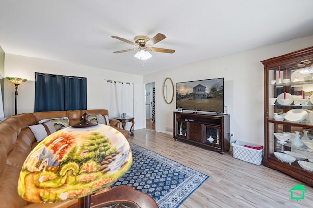 bedroom with ceiling fan, baseboards, and wood finished floors