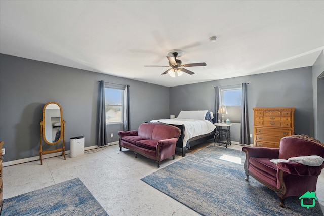 bedroom with multiple windows, baseboards, and ceiling fan