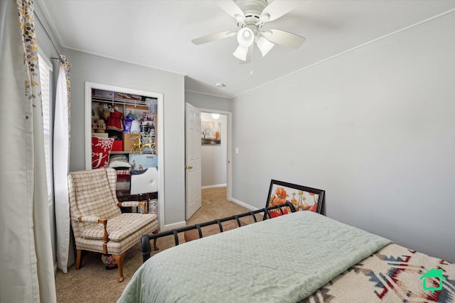 bedroom featuring crown molding, baseboards, carpet flooring, a closet, and a ceiling fan