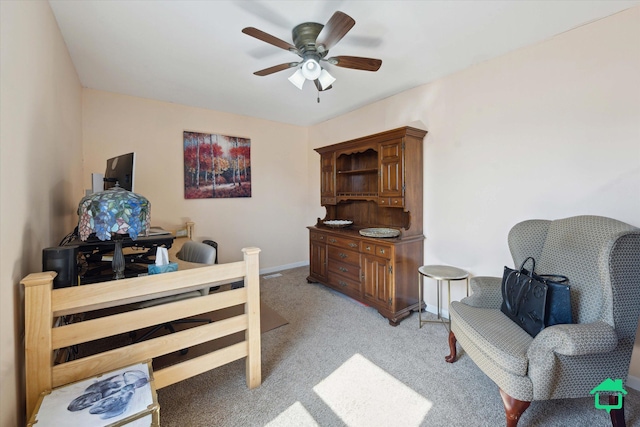 interior space with baseboards, light carpet, and ceiling fan