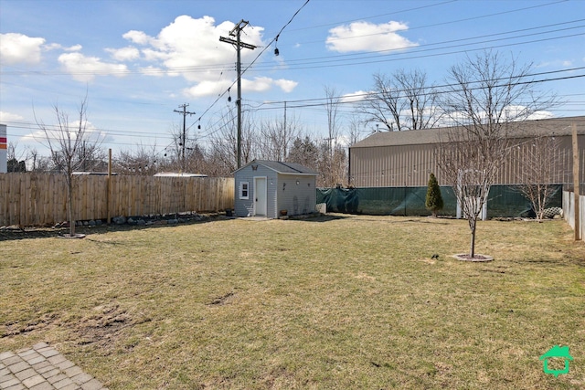 view of yard featuring an outbuilding, a fenced backyard, and a storage shed