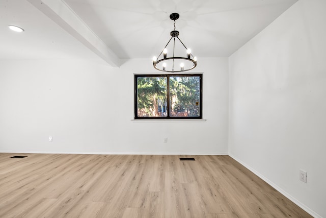 empty room featuring visible vents, baseboards, light wood-style floors, and an inviting chandelier