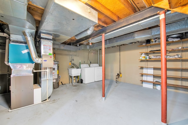 unfinished basement with gas water heater and independent washer and dryer