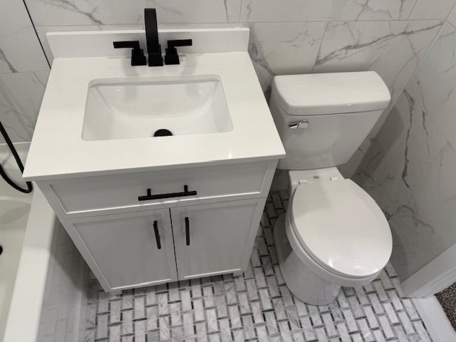 bathroom featuring toilet and vanity