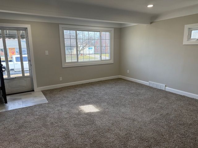 carpeted entryway featuring beam ceiling, visible vents, recessed lighting, and baseboards