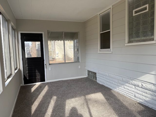 unfurnished sunroom with visible vents