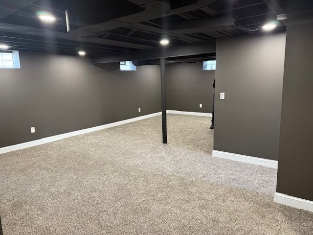 below grade area with baseboards and carpet