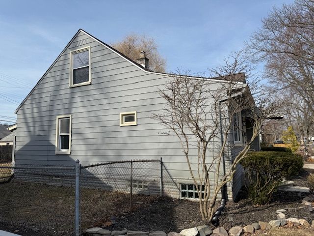 view of side of home with fence