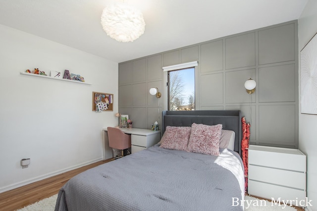 bedroom featuring wood finished floors and baseboards