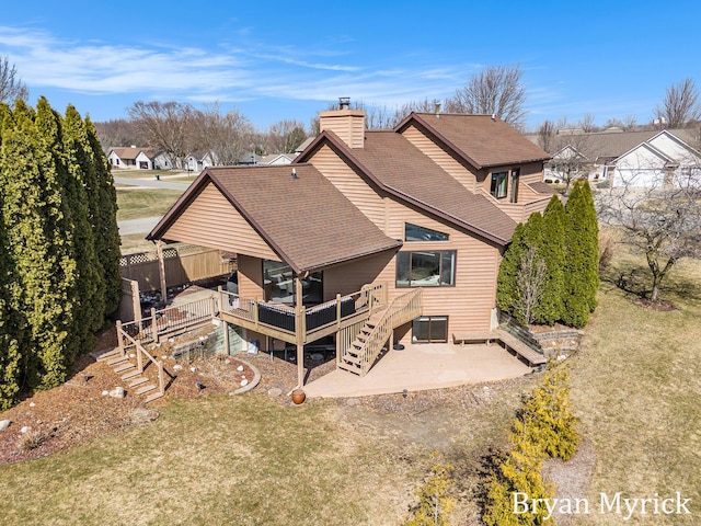 back of property with stairs, roof with shingles, a lawn, a chimney, and a patio