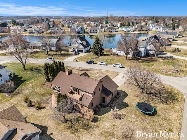 drone / aerial view featuring a residential view and a water view