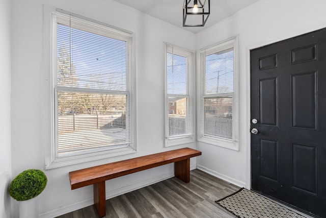 foyer featuring wood finished floors and baseboards