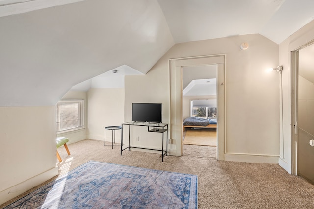 additional living space featuring vaulted ceiling, carpet, and baseboards