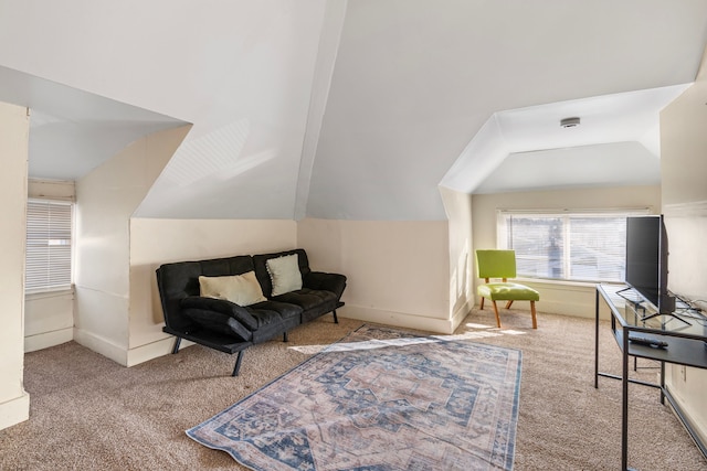 living area with vaulted ceiling, baseboards, and carpet floors