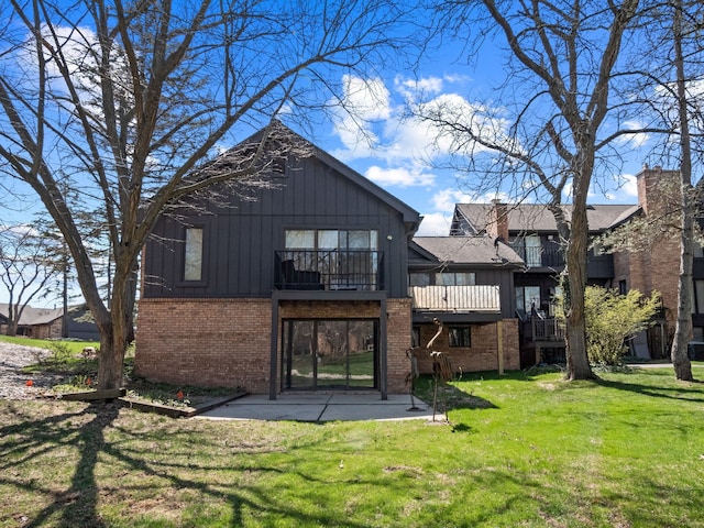 1920 Pine Ridge Ln, Bloomfield Hills, MI 48302 - rear view of property with brick siding, a balcony, a lawn, board and batten siding, and a patio