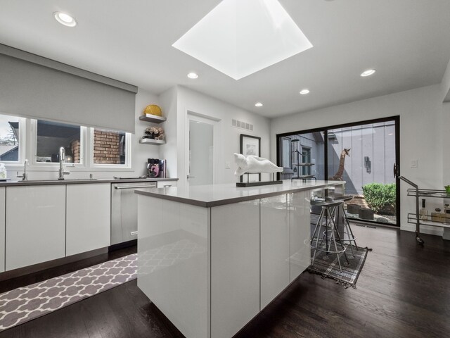 1920 Pine Ridge Ln, Bloomfield Hills, MI 48302 - kitchen with stainless steel dishwasher, white cabinetry, recessed lighting, dark wood-style floors, and a center island