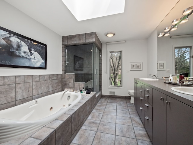 1920 Pine Ridge Ln, Bloomfield Hills, MI 48302 - full bath featuring a tub with jets, double vanity, a shower stall, tile patterned floors, and a skylight