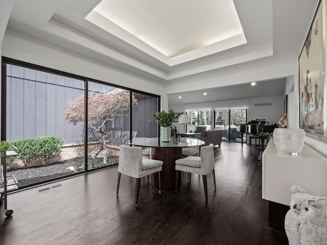 1920 Pine Ridge Ln, Bloomfield Hills, MI 48302 - dining area featuring a tray ceiling and dark wood-type flooring
