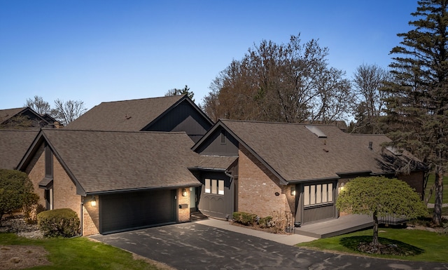 1920 Pine Ridge Ln, Bloomfield Hills, MI 48302 - view of front of house featuring brick siding, asphalt driveway, a garage, roof with shingles, and board and batten siding