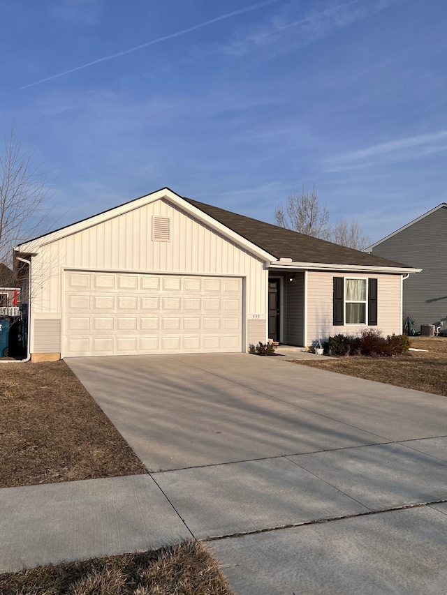 single story home featuring a garage, board and batten siding, and concrete driveway