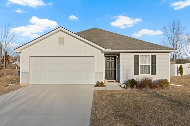 ranch-style home featuring an attached garage, concrete driveway, a front lawn, and fence