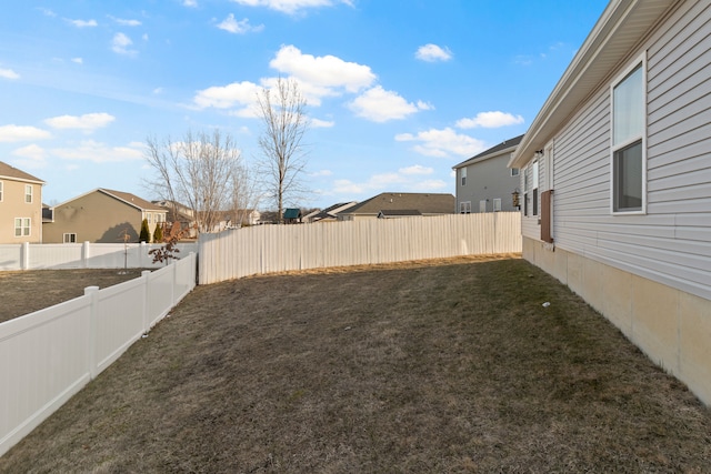 view of yard with a residential view and a fenced backyard