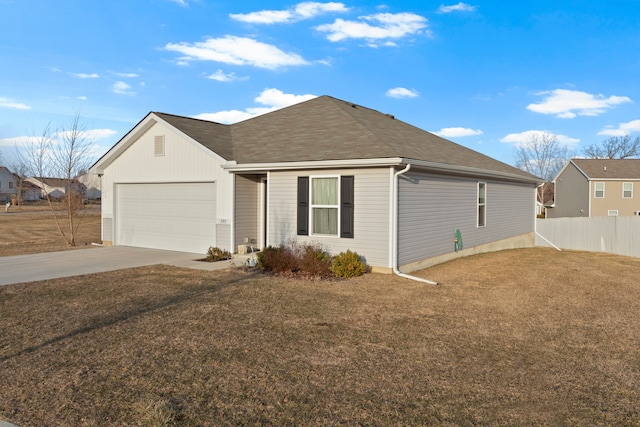 single story home with an attached garage, driveway, a front yard, and fence