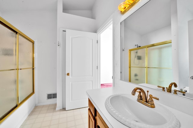 bathroom featuring tile patterned floors, visible vents, bath / shower combo with glass door, and vanity