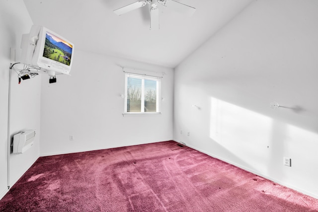 spare room featuring a wall mounted air conditioner, carpet, ceiling fan, and vaulted ceiling