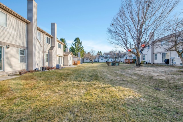 view of yard featuring central air condition unit and a residential view