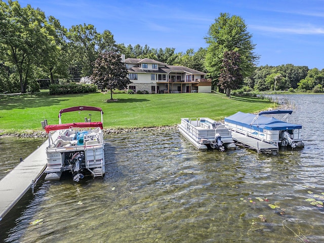 view of dock with a yard and a water view