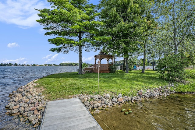 view of dock featuring a gazebo, a lawn, and a water view