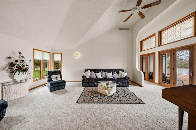 living room featuring visible vents, a ceiling fan, a textured ceiling, carpet, and baseboards