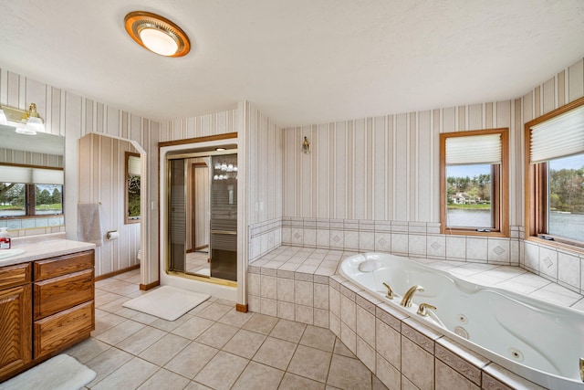 full bathroom featuring tile patterned flooring, a healthy amount of sunlight, and wallpapered walls