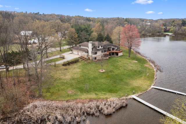 aerial view featuring a wooded view and a water view