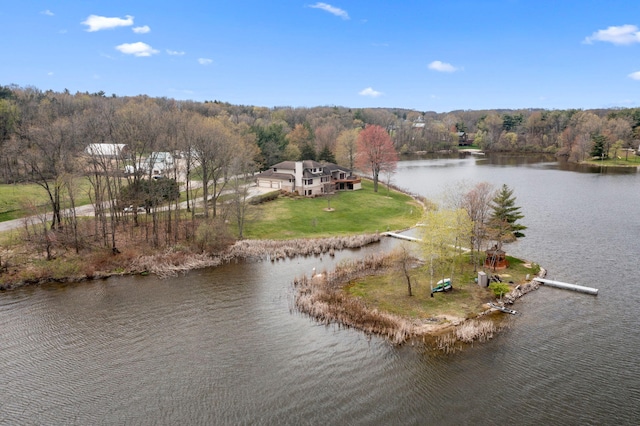 aerial view with a forest view and a water view